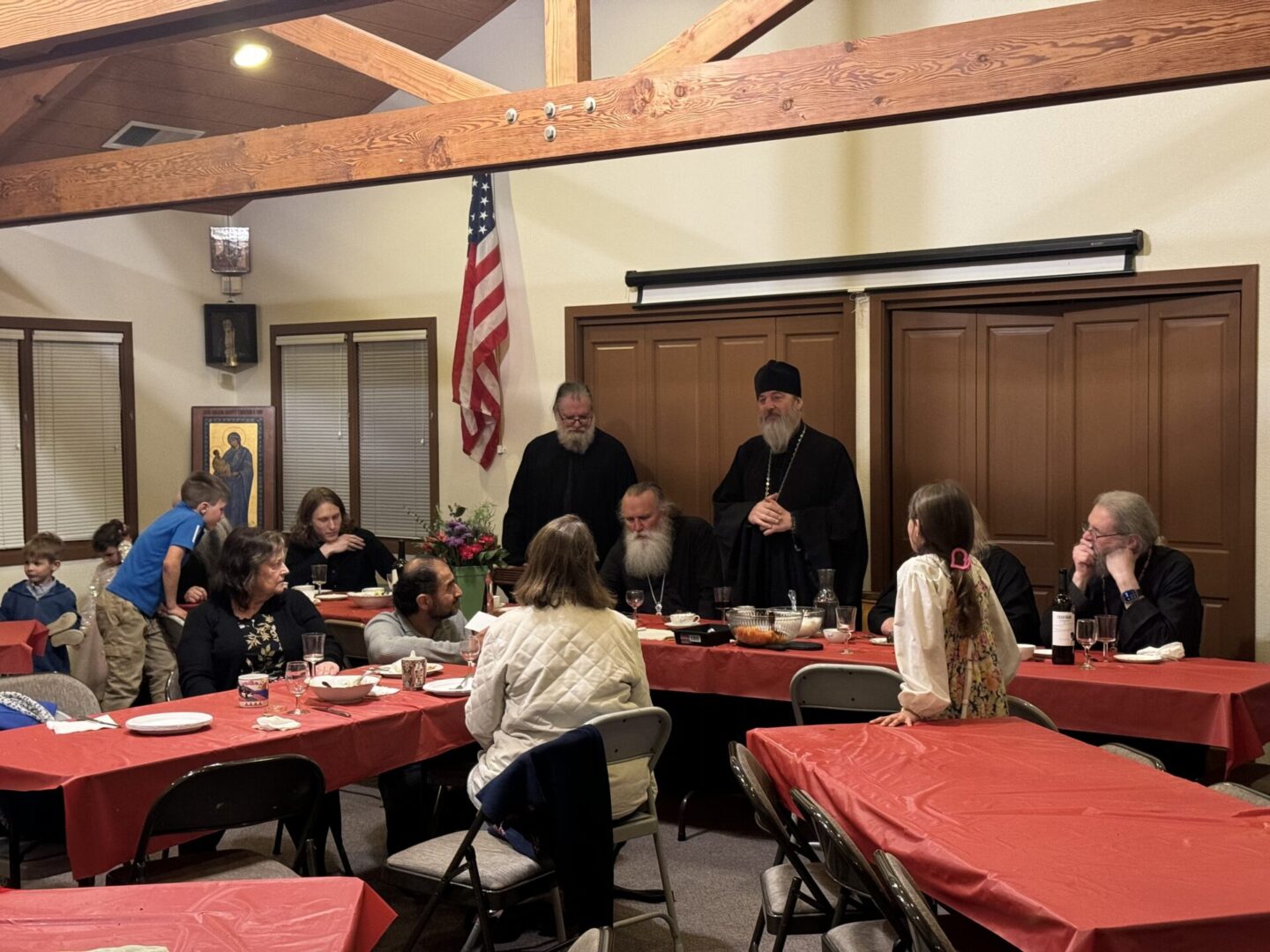 A group of people sitting at tables with plates.