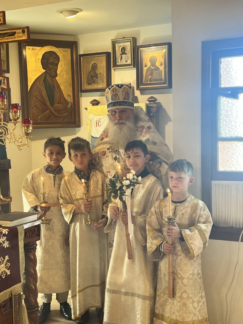 A group of children dressed in white and holding candles.